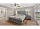 This bedroom features an en suite bathroom, stylish furniture, and an outdoor view at 24277 Treasure Island Blvd, Punta Gorda, FL 33955