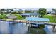 Waterfront home featuring a private boat dock with tiki hut, boat lift and screened porch at 24277 Treasure Island Blvd, Punta Gorda, FL 33955