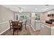 Charming dining area open to the kitchen, featuring sliding doors to the lanai and water views at 24277 Treasure Island Blvd, Punta Gorda, FL 33955