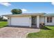 Home's exterior featuring a two-car garage and a brick paved driveway at 24277 Treasure Island Blvd, Punta Gorda, FL 33955