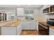 Bright kitchen with white cabinets, neutral countertops and tile backsplash with stainless appliances at 24277 Treasure Island Blvd, Punta Gorda, FL 33955