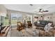 Well-lit living room with comfortable seating, wood-look floors and large windows at 24277 Treasure Island Blvd, Punta Gorda, FL 33955