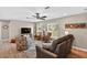 Cozy living room with wood floors, large windows, modern furniture, and a ceiling fan at 24277 Treasure Island Blvd, Punta Gorda, FL 33955