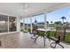 A screened-in patio featuring tiled floors, a ceiling fan, and a beautiful waterfront view at 24277 Treasure Island Blvd, Punta Gorda, FL 33955