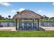 Relaxing waterfront tiki hut with rocking chairs, perfect for enjoying scenic water views at 24277 Treasure Island Blvd, Punta Gorda, FL 33955