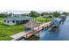 Waterfront property boasts a private dock with boat lift and tiki hut, perfect for relaxation at 24277 Treasure Island Blvd, Punta Gorda, FL 33955