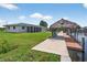 Scenic waterfront property featuring a boat dock, tiki hut, and lush green lawn at 24277 Treasure Island Blvd, Punta Gorda, FL 33955