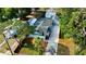 Aerial view of a charming blue home, with mature landscaping and a detached garage at 6020 Illinois Ave, New Port Richey, FL 34653