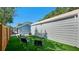 Spacious backyard with well-maintained turf, detached garage, and seating area at 6020 Illinois Ave, New Port Richey, FL 34653