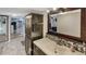 This bathroom has a vanity with a decorative mirror and wood-look floors at 6020 Illinois Ave, New Port Richey, FL 34653