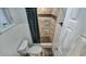 This bathroom has a black and white tile shower and a toilet at 6020 Illinois Ave, New Port Richey, FL 34653