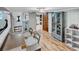 Modern dining room with wood floors, stylish barn door leading to the kitchen, and ample lighting at 6020 Illinois Ave, New Port Richey, FL 34653