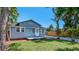 Charming single-story home with blue exterior, brick accents, and a well-manicured lawn at 6020 Illinois Ave, New Port Richey, FL 34653