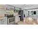 Modern kitchen featuring stainless steel appliances and an adjacent dining and living space at 6020 Illinois Ave, New Port Richey, FL 34653