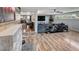 Open-concept living area with stylish accents, a TV, and seamless flow to other areas of the home at 6020 Illinois Ave, New Port Richey, FL 34653