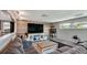 This living room has light colored floors, a grey sofa, a large television, and a cat tower at 6020 Illinois Ave, New Port Richey, FL 34653
