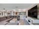 Comfortable living room featuring a large sectional sofa, wood-look floors, and a stylish entertainment center at 6020 Illinois Ave, New Port Richey, FL 34653