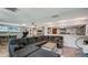 A full view of the spacious living room featuring a grey sofa, with light colored floors, and decor at 6020 Illinois Ave, New Port Richey, FL 34653