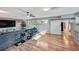 Spacious living room with light colored floors, a gray sofa and a shoe rack at 6020 Illinois Ave, New Port Richey, FL 34653