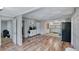 Open living space featuring wood-look floors, stylish cabinetry, and seamless flow to the kitchen at 6020 Illinois Ave, New Port Richey, FL 34653