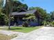 Charming blue bungalow featuring a well-manicured lawn and inviting curb appeal at 834 Jackson N St, St Petersburg, FL 33705
