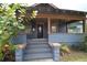 Charming front porch with blue wood paneling, ceiling fans, and a welcoming entrance at 834 Jackson N St, St Petersburg, FL 33705