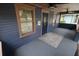 Inviting front porch with blue wood paneling, a decorative door, and overhead fans at 834 Jackson N St, St Petersburg, FL 33705