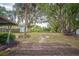 Large backyard with mature trees and a small shed at 101 N Nimbus Ave, Clearwater, FL 33765