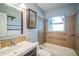 Bathroom with a tub, updated vanity, and decorative mirrors at 101 N Nimbus Ave, Clearwater, FL 33765