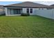 A spacious backyard with lush green grass and a privacy fence, perfect for outdoor activities at 12513 Oak Hill Way, Parrish, FL 34219