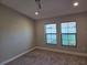 Cozy bedroom with carpet, neutral walls, ceiling fan and a double window with wood blinds at 12513 Oak Hill Way, Parrish, FL 34219