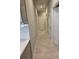 Hallway features neutral paint, white trim, and wood look ceramic tile flooring at 12513 Oak Hill Way, Parrish, FL 34219
