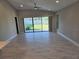 Open concept living room with ceramic tile floors and large windows allowing lots of natural light at 12513 Oak Hill Way, Parrish, FL 34219