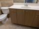 Functional bathroom showcasing a vanity with cabinet storage, toilet, and neutral tile flooring at 141 Angol St, Punta Gorda, FL 33983