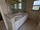 Bathroom with double vanity, mirror, and tile flooring at 141 Angol St, Punta Gorda, FL 33983