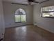 Bright bedroom featuring a stylish arched window and a ceiling fan at 141 Angol St, Punta Gorda, FL 33983