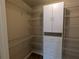 Walk-in closet with adjustable shelving and a central storage unit at 141 Angol St, Punta Gorda, FL 33983