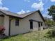 Side exterior view of the house with a well-maintained lawn and landscaping at 141 Angol St, Punta Gorda, FL 33983