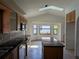 Spacious kitchen with modern appliances, granite countertops, tile backsplash, a kitchen island, and ample cabinet space at 141 Angol St, Punta Gorda, FL 33983