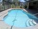Refreshing in-ground pool featuring screened enclosure, a charming fish mosaic, and convenient step access at 141 Angol St, Punta Gorda, FL 33983