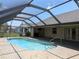 Sparkling in-ground pool with a screened-in enclosure, steps and a relaxing outdoor living space at 141 Angol St, Punta Gorda, FL 33983