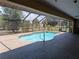 Inviting in-ground pool area complete with screened enclosure and well-maintained brick pavers at 141 Angol St, Punta Gorda, FL 33983