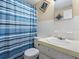 Bathroom showcasing a single sink vanity, a toilet, and a shower/tub with tiled walls at 20703 Old Trilby Rd, Dade City, FL 33523