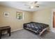 Bedroom featuring a comfortable bed, neutral carpet, a ceiling fan, and a window with natural light at 20703 Old Trilby Rd, Dade City, FL 33523