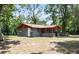 Rear exterior view of the charming one-story home with an attached screened porch and spacious yard at 20703 Old Trilby Rd, Dade City, FL 33523