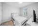 Minimalist bedroom with a neatly made bed, side table, and simple decor for a serene setting at 28761 Sweet Persimmon Dr, Wesley Chapel, FL 33543