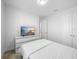 Bright bedroom features white walls, a large dresser and mounted television for comfortable, modern living at 28761 Sweet Persimmon Dr, Wesley Chapel, FL 33543