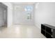 Bright dining room boasts tile floors, high ceilings, modern chandelier, and natural light from large windows at 28761 Sweet Persimmon Dr, Wesley Chapel, FL 33543