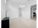 Dining room showcasing neutral tile floors, modern lighting fixture, and a serene view into the adjacent bedroom at 28761 Sweet Persimmon Dr, Wesley Chapel, FL 33543