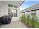 Enjoy outdoor living with this covered patio, featuring tiled floors and views of the lush backyard at 28761 Sweet Persimmon Dr, Wesley Chapel, FL 33543